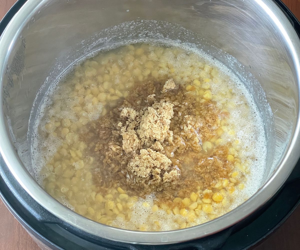 A pot is with cooked chana dal and jaggery.