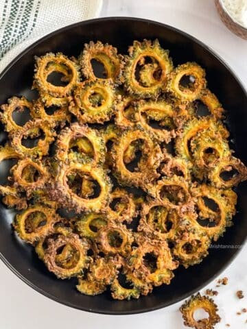 Head shot of karela chips on the plate.