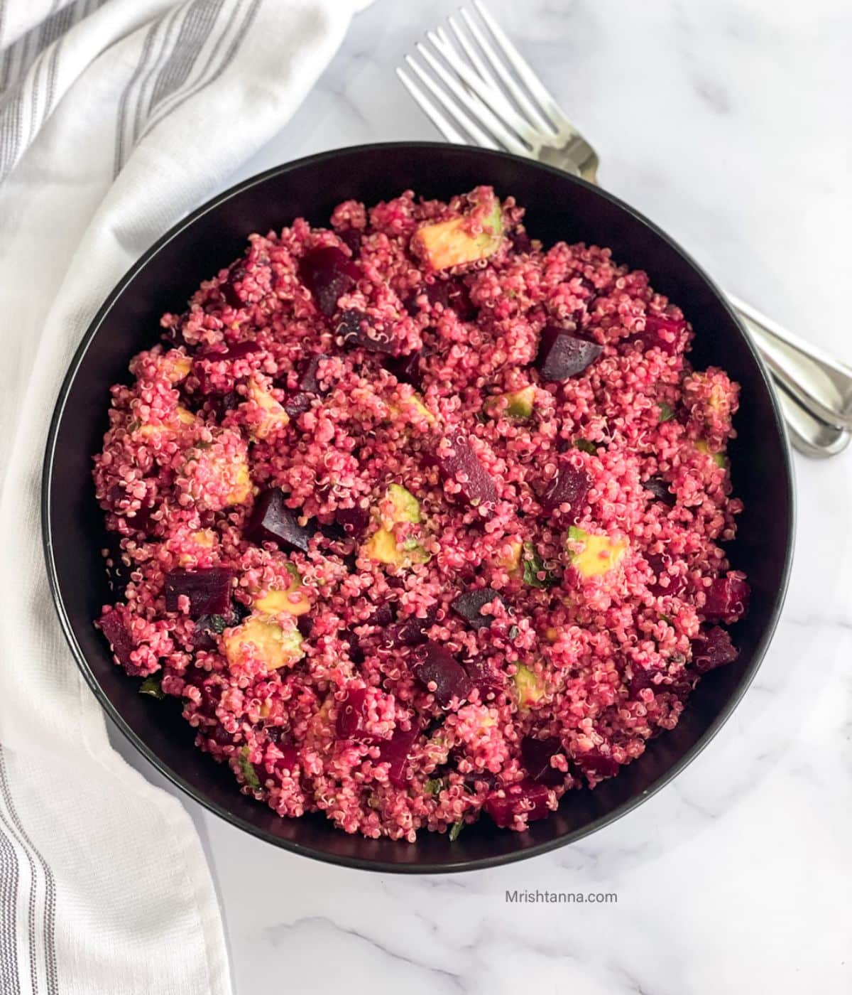 Head shot of plate with quinoa salad with beets and avocado.