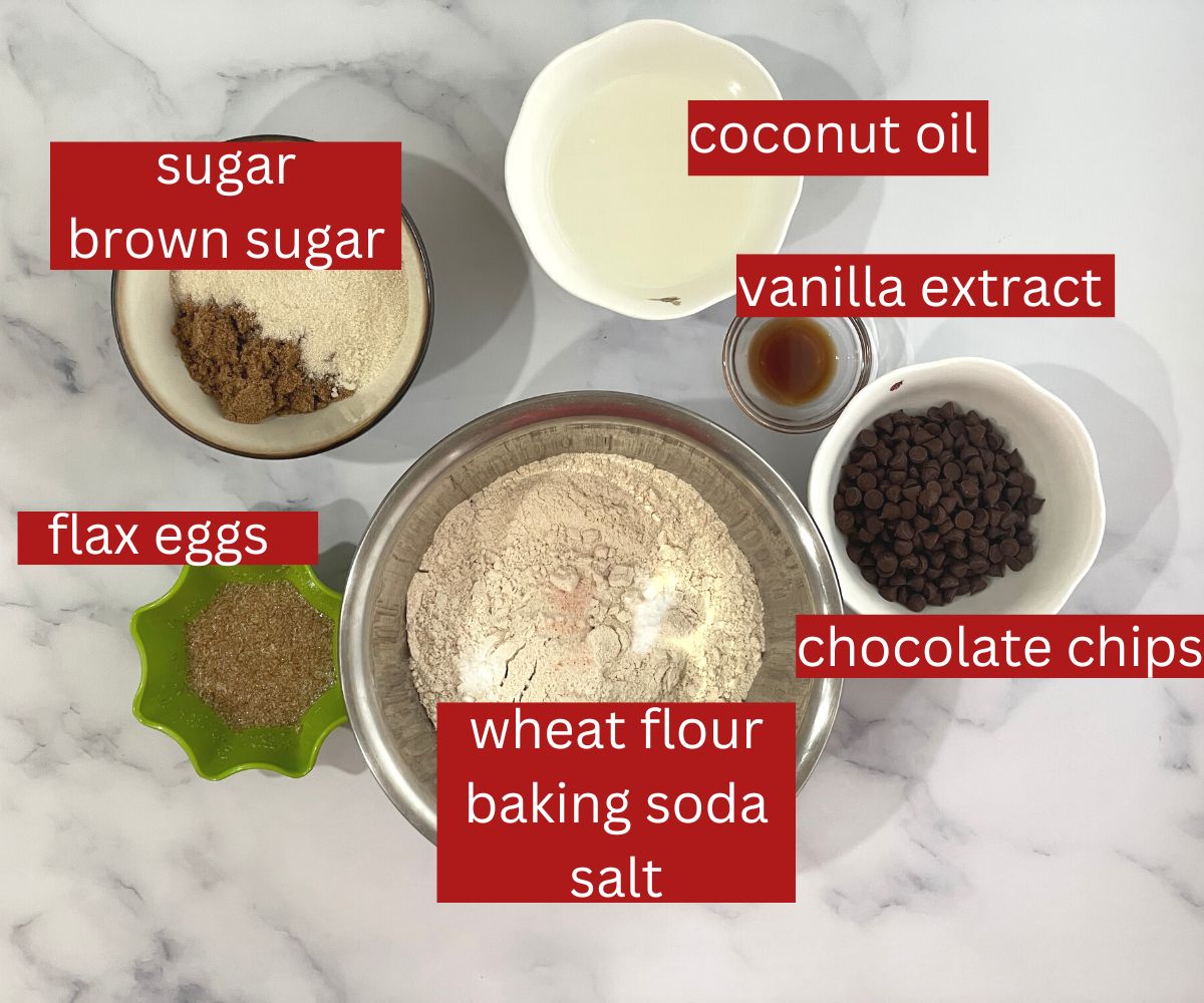 A table is covered with chocolate chip cookies ingredients.