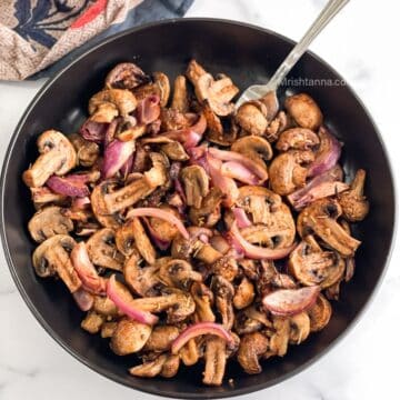 head shot of plate with air fryer mushrooms and onions recipe.