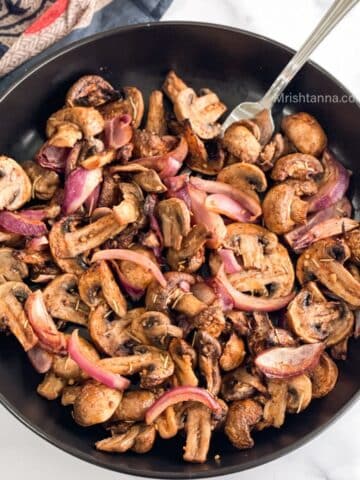 head shot of plate with air fryer mushrooms and onions recipe.