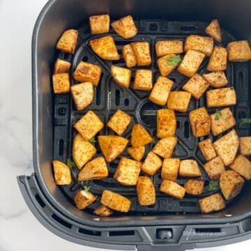 Air fryer roasted turnips is inside the air fryer basket.