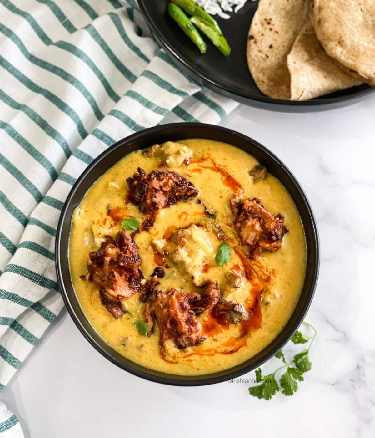 Head shot of bowl with Punjabi kadhi pakora curry.