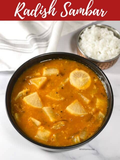 A bowl of Mullangi sambar is on the table with cloth and a small bowl of rice.