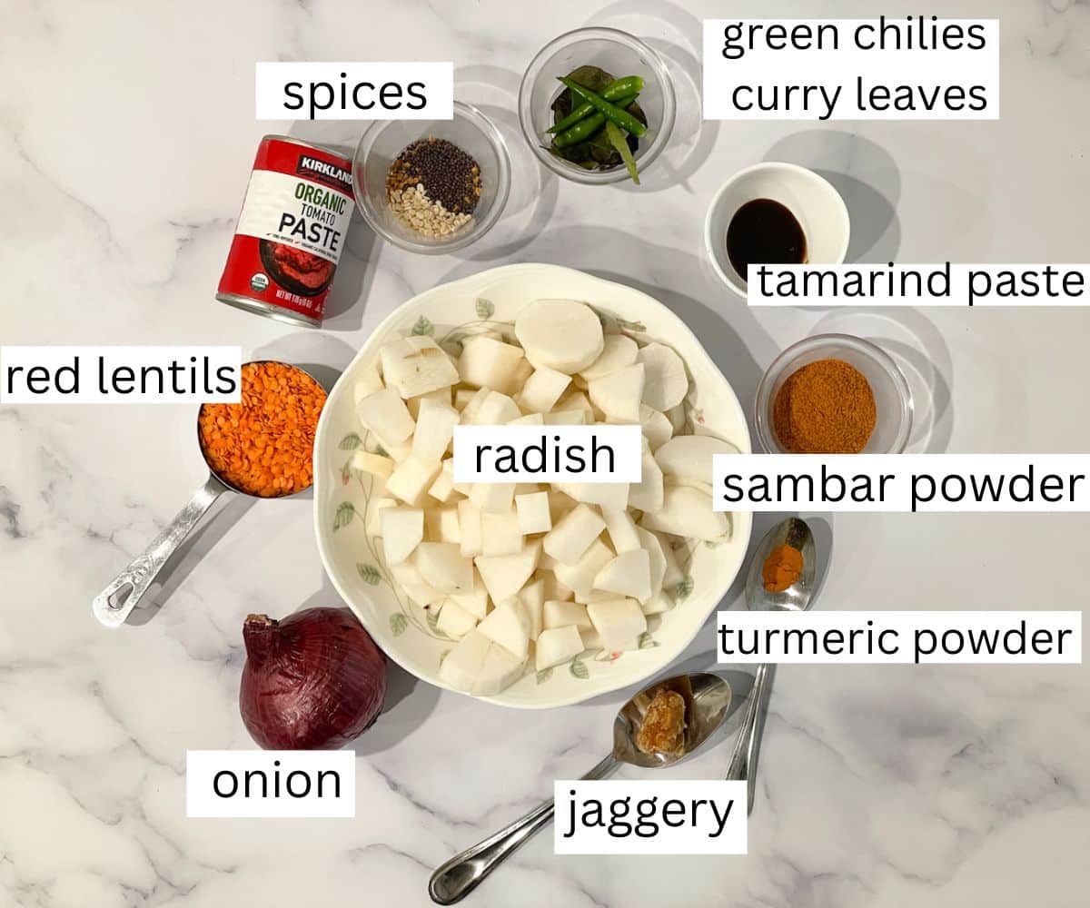 A table is covered with radish sambar ingredients.