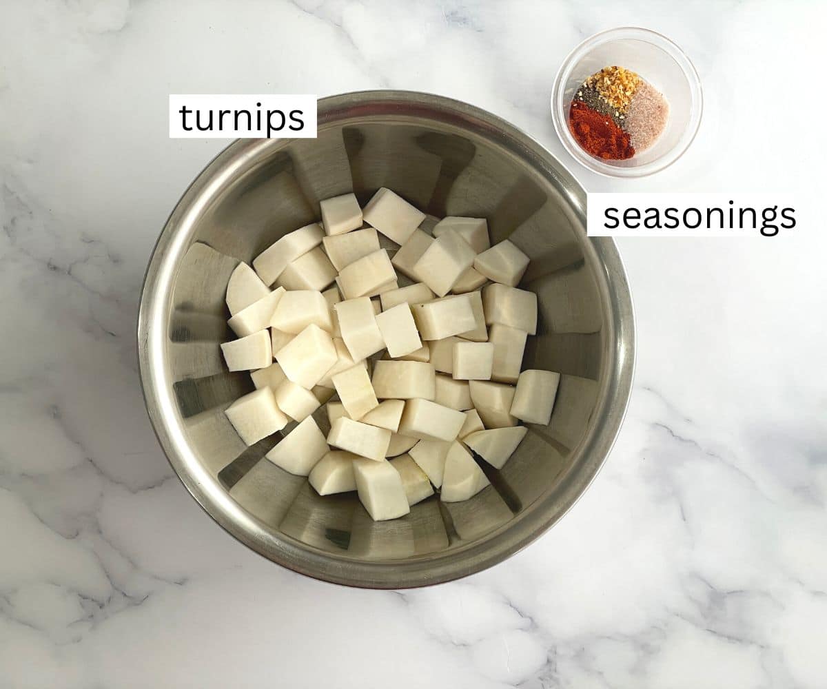 A table is with a bowl of chopped turnips and seasonings.