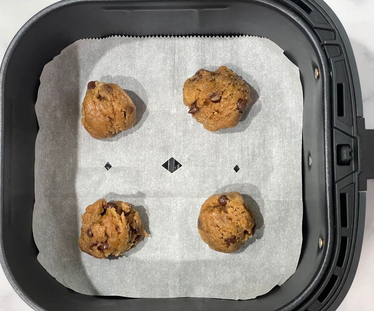 Air fryer basket is with vegan chocolate chip cookie dough.