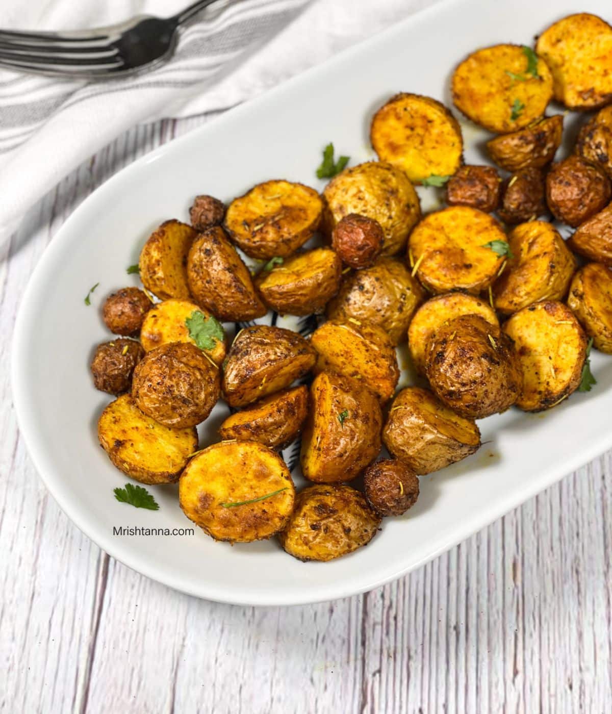 A tray of air fryer mini potatoes is on the table.