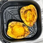 The air fryer roasted acorn squash is in the basket.