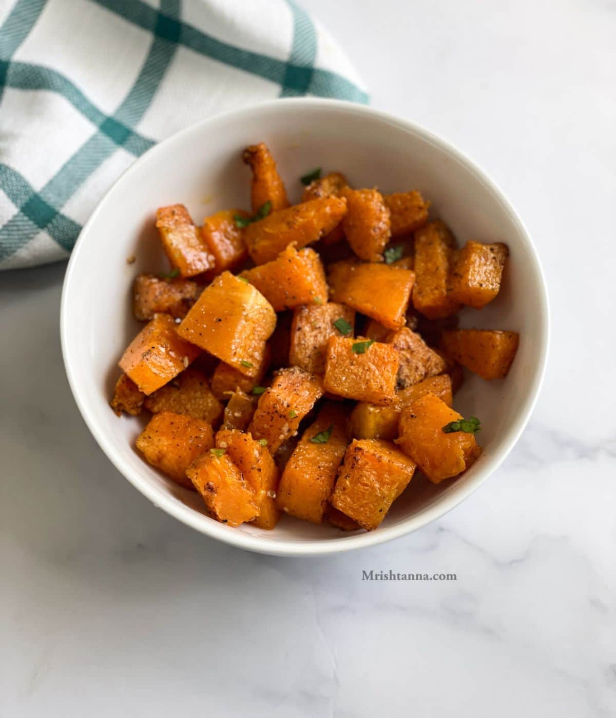 A bowl is with air fryer pumpkin on the table.