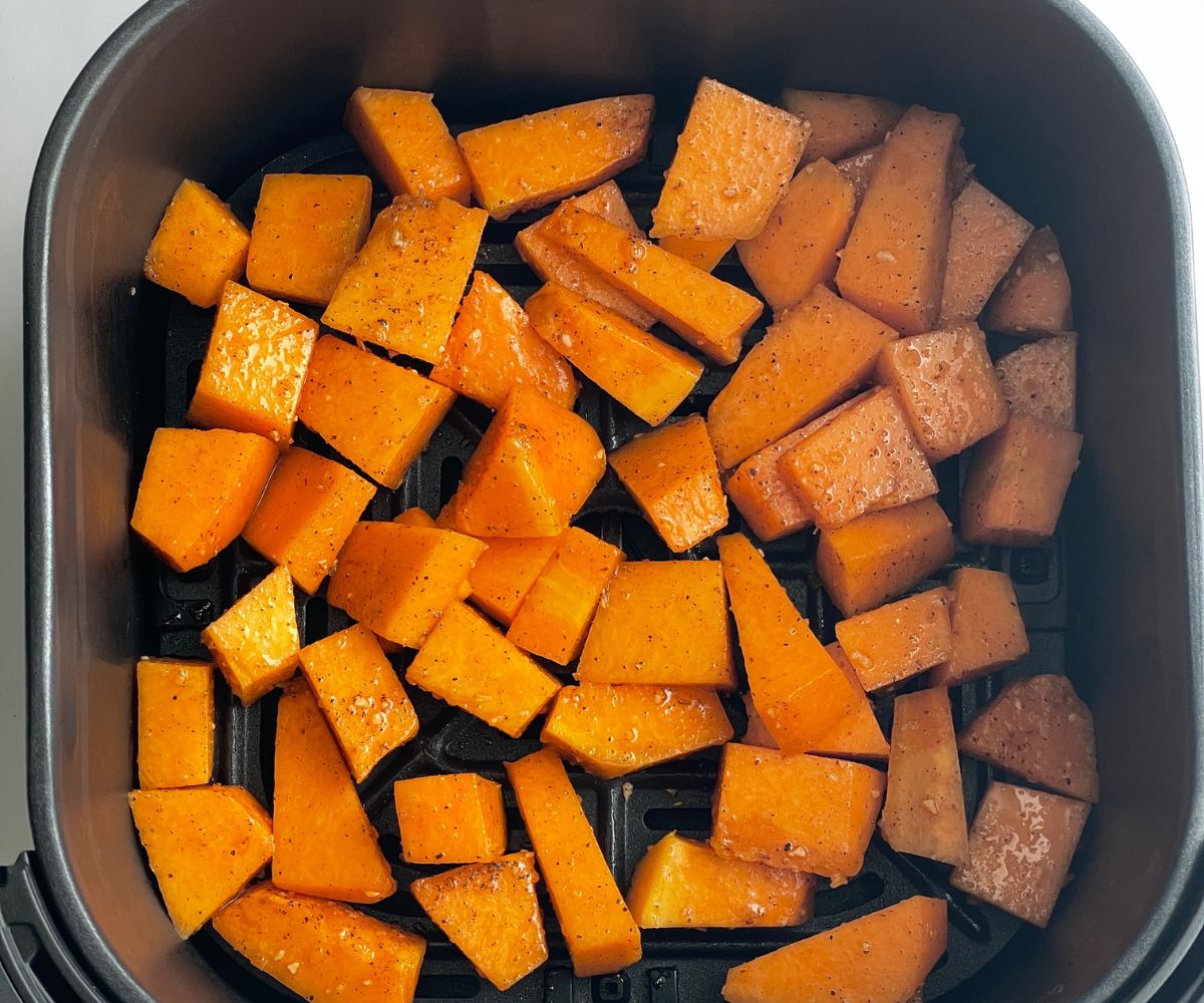 Air fryer basket is with seasoned pumpkins.