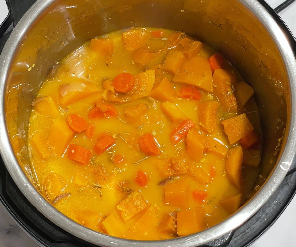 A pot is with butternut soup mixture.