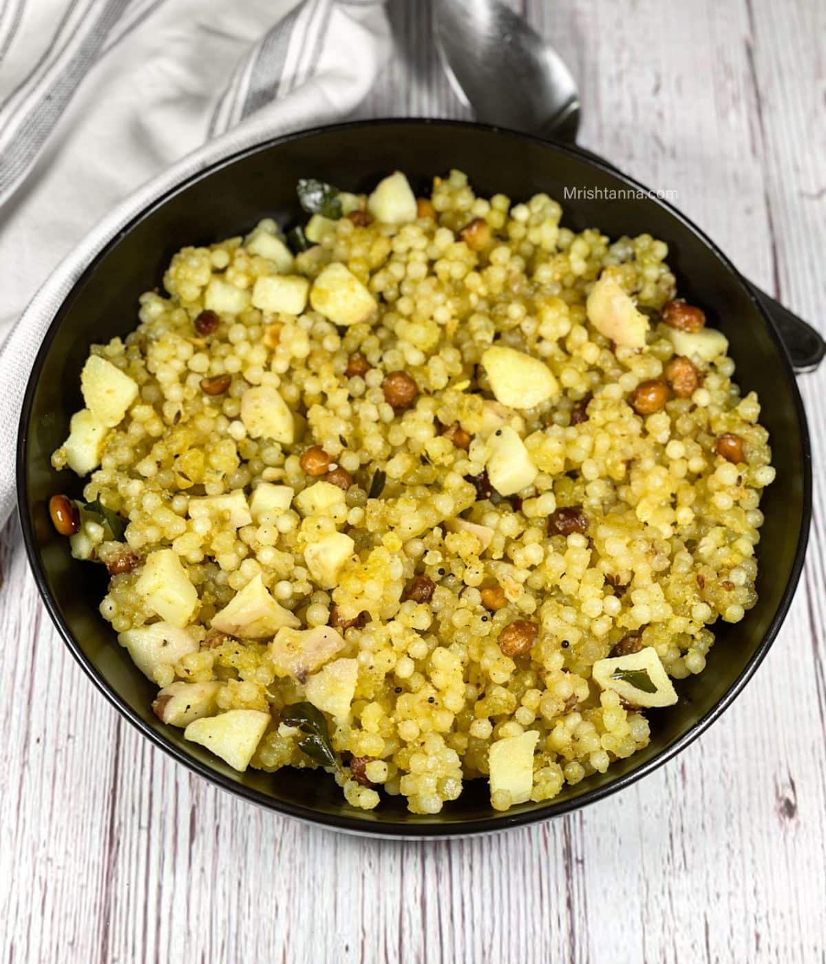 A plate of sabudana upma is on the table.