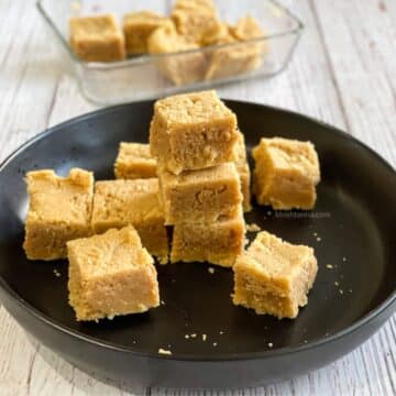 A plate is stacked with vegan Mysore Pak sweets.