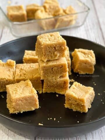 A plate is stacked with vegan Mysore Pak sweets.