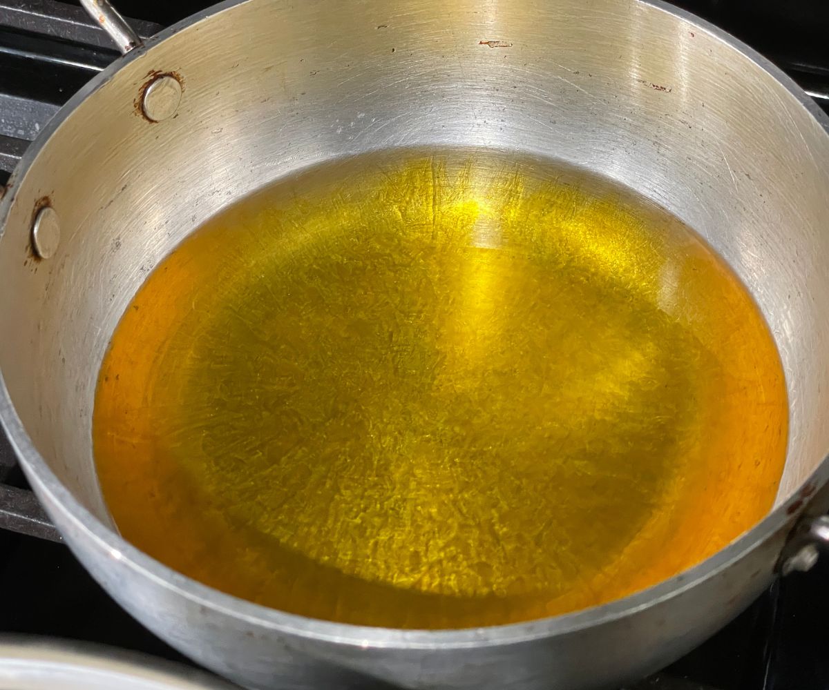 A pot is with avocado oil and vegan ghee over the low  heat.