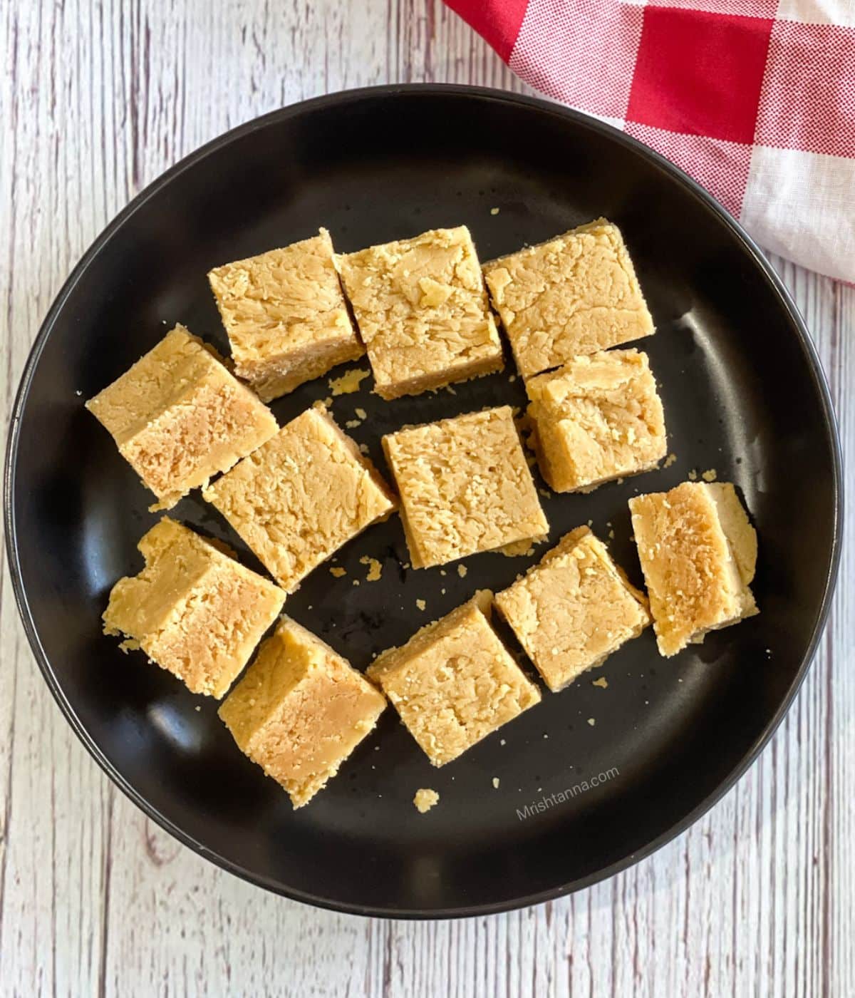 A plate is with vegan mysore pak pieces. 