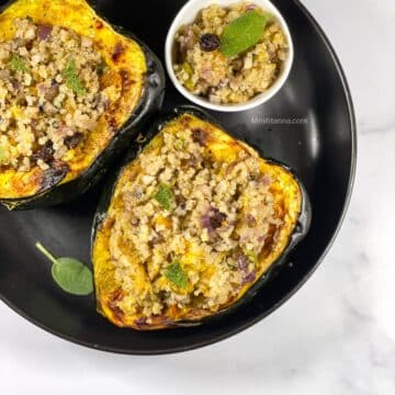 A plate of vegan quinoa stuffed acorn squash is on the table.