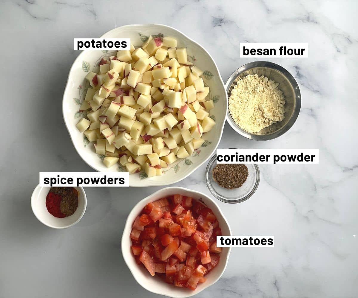 Aloo tomato curry ingredients are on the table.