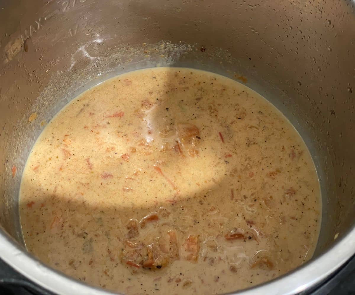 An instant pot is with Cajun pasta sauce.
