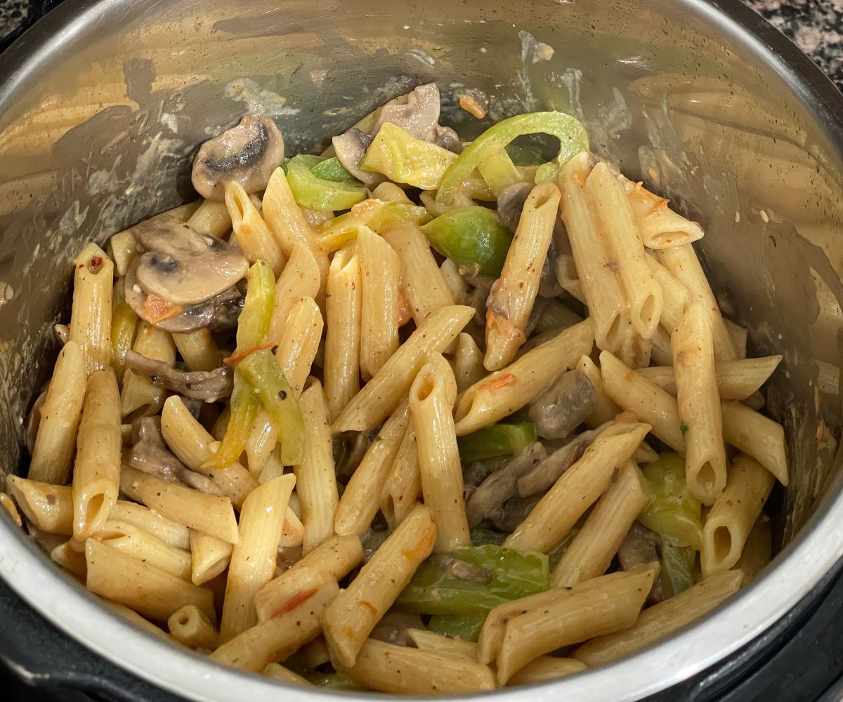 An instant pot is with vegan cajun pasta.