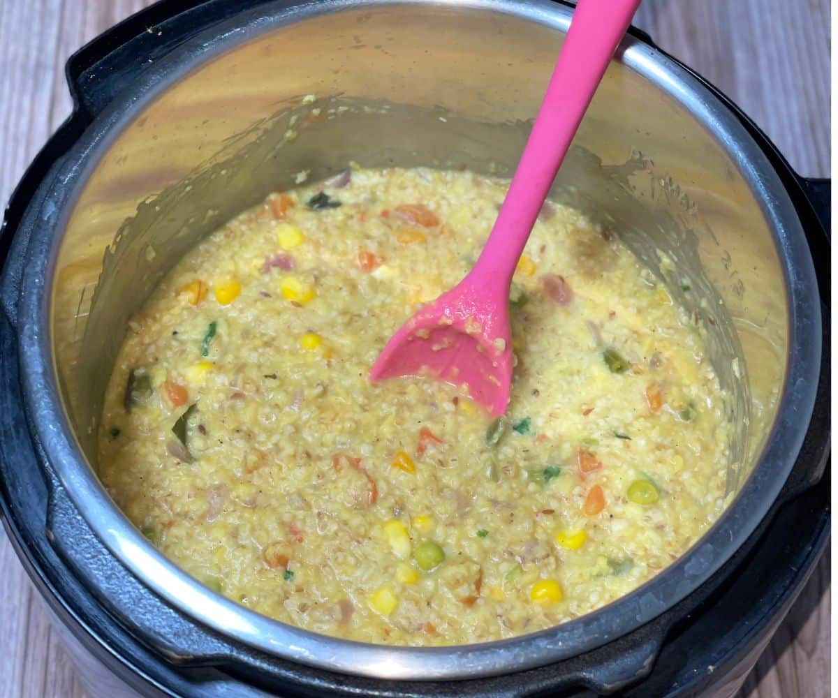 An instant pot is filled with oats khichdi.