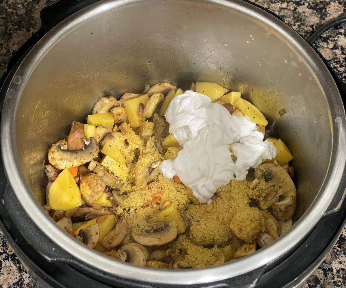 An instant pot is with potato mushroom soup mixture.