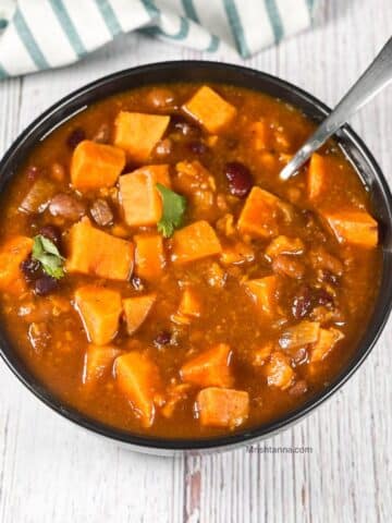 A bowl is filled with instant pot sweet potato chili.