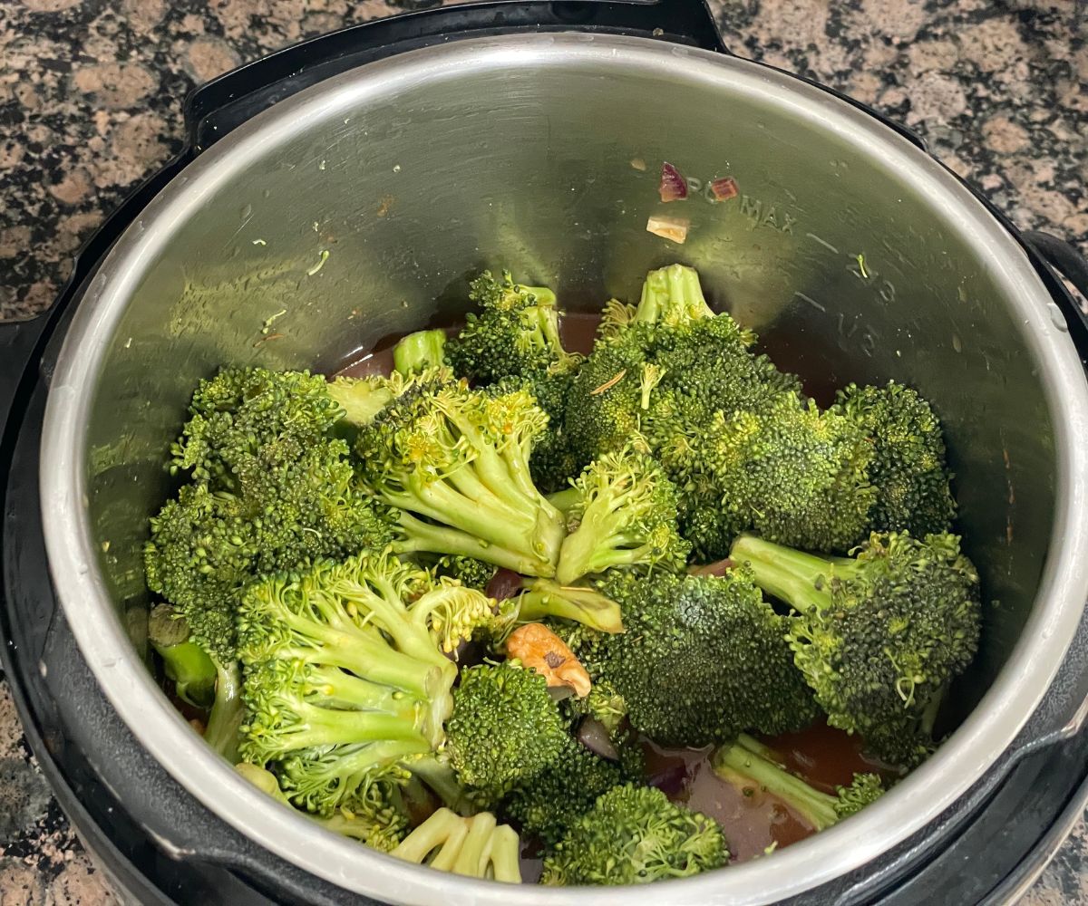 A pot is with spices, broccoli florets for soup.