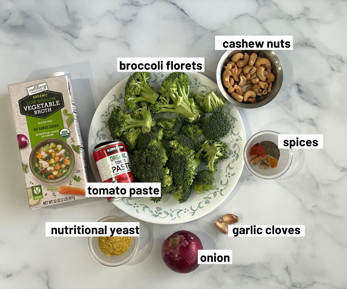 A table is with broccoli tomato soup ingredients.