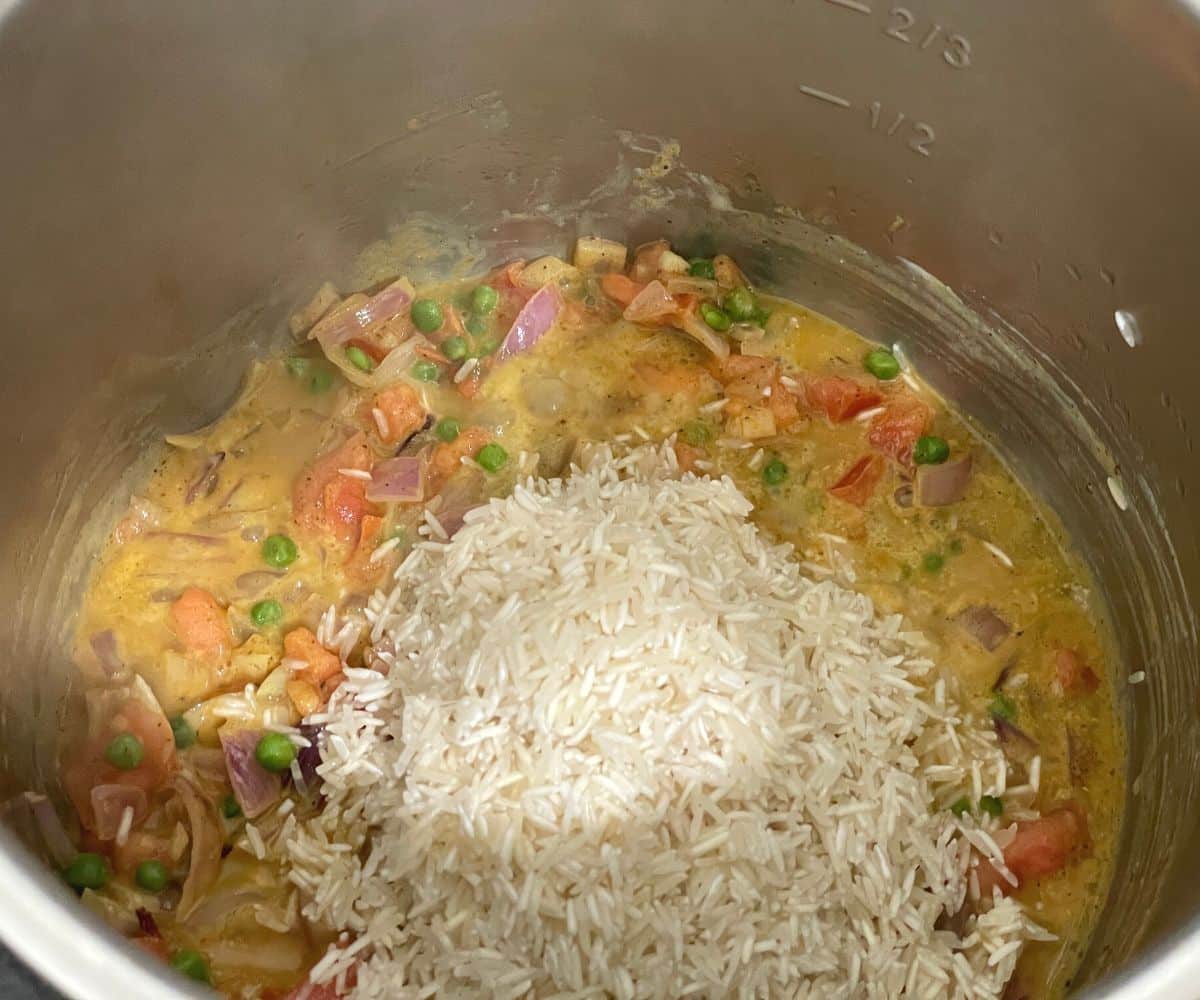 A pot is with rice and curry masala.