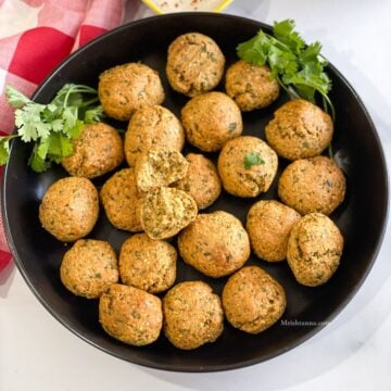 A plate of Trader joe's falafel is on the table.