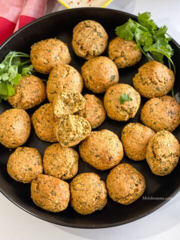 A plate of Trader joe's falafel is on the table.