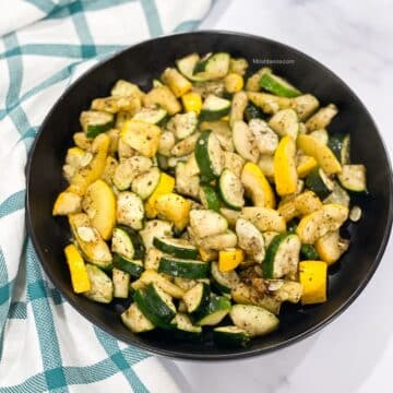 A plate of air fryer zucchini is on the table.