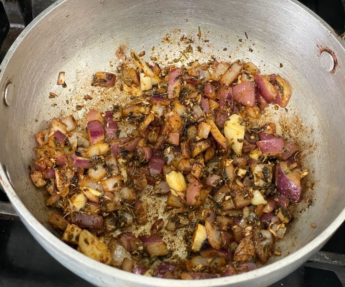 A pan is with tempering for sarson ka saag curry.