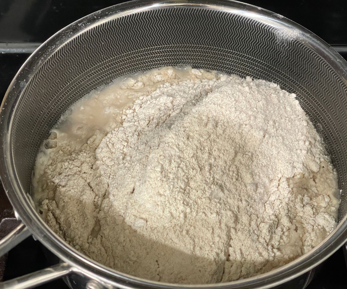 A pot is with hot water and sorghum flour.