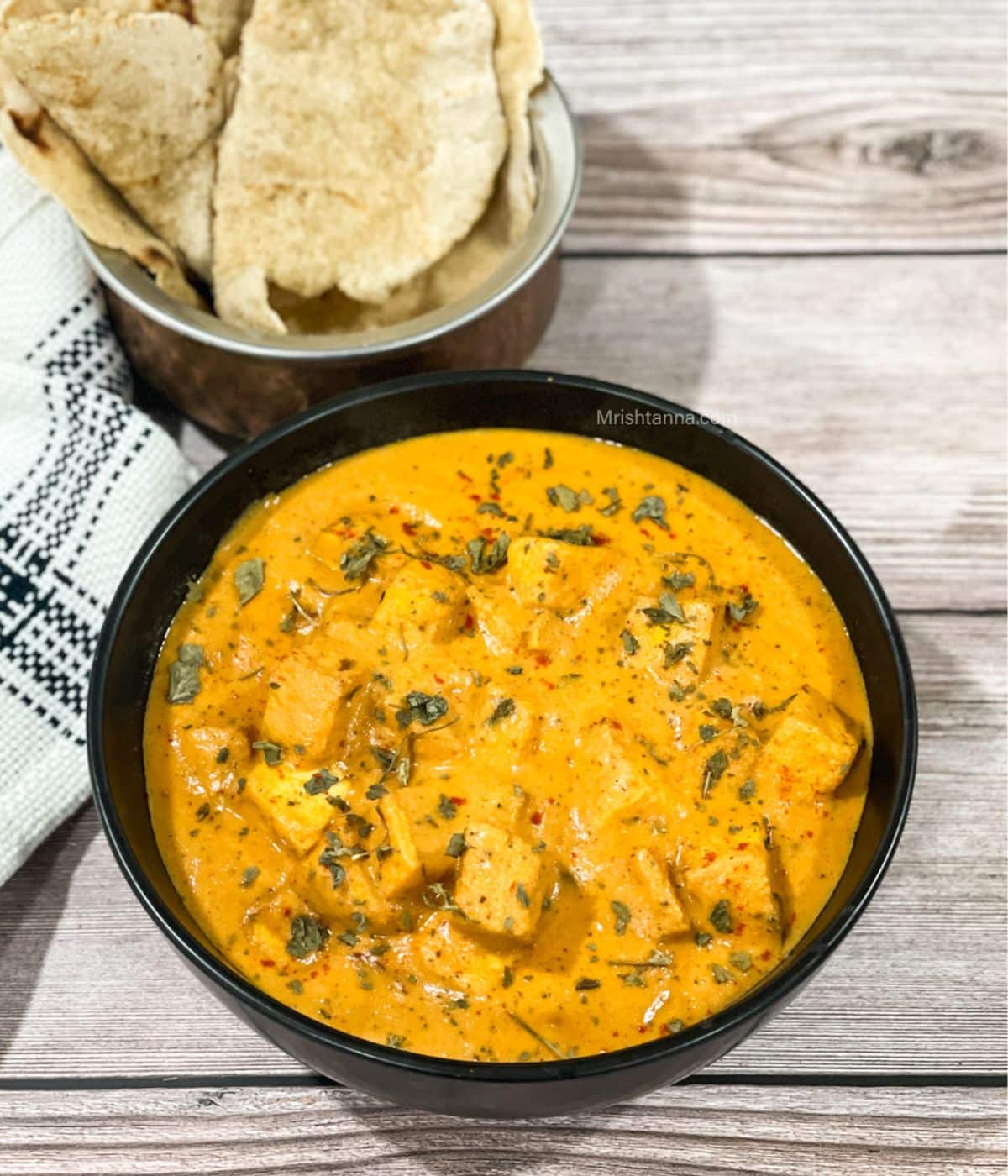 A bowl of tofu makhani is on the table.