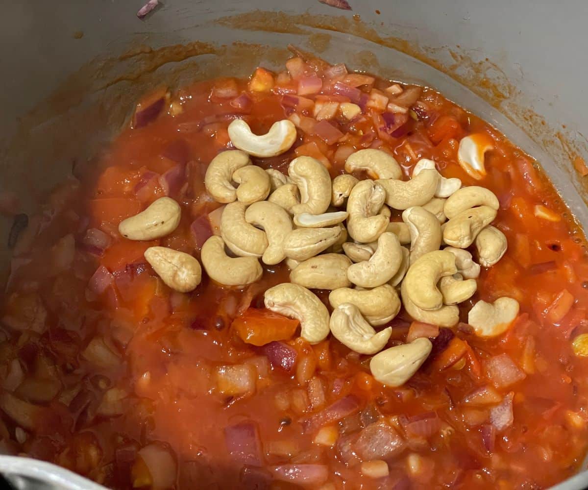 A pot is with tofu makhani sauce masala over the heat.