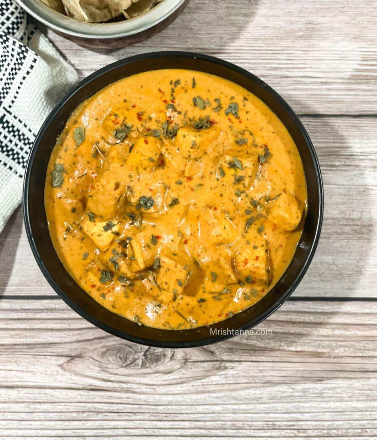 The head shot of a bowl with tofu makhani curry.