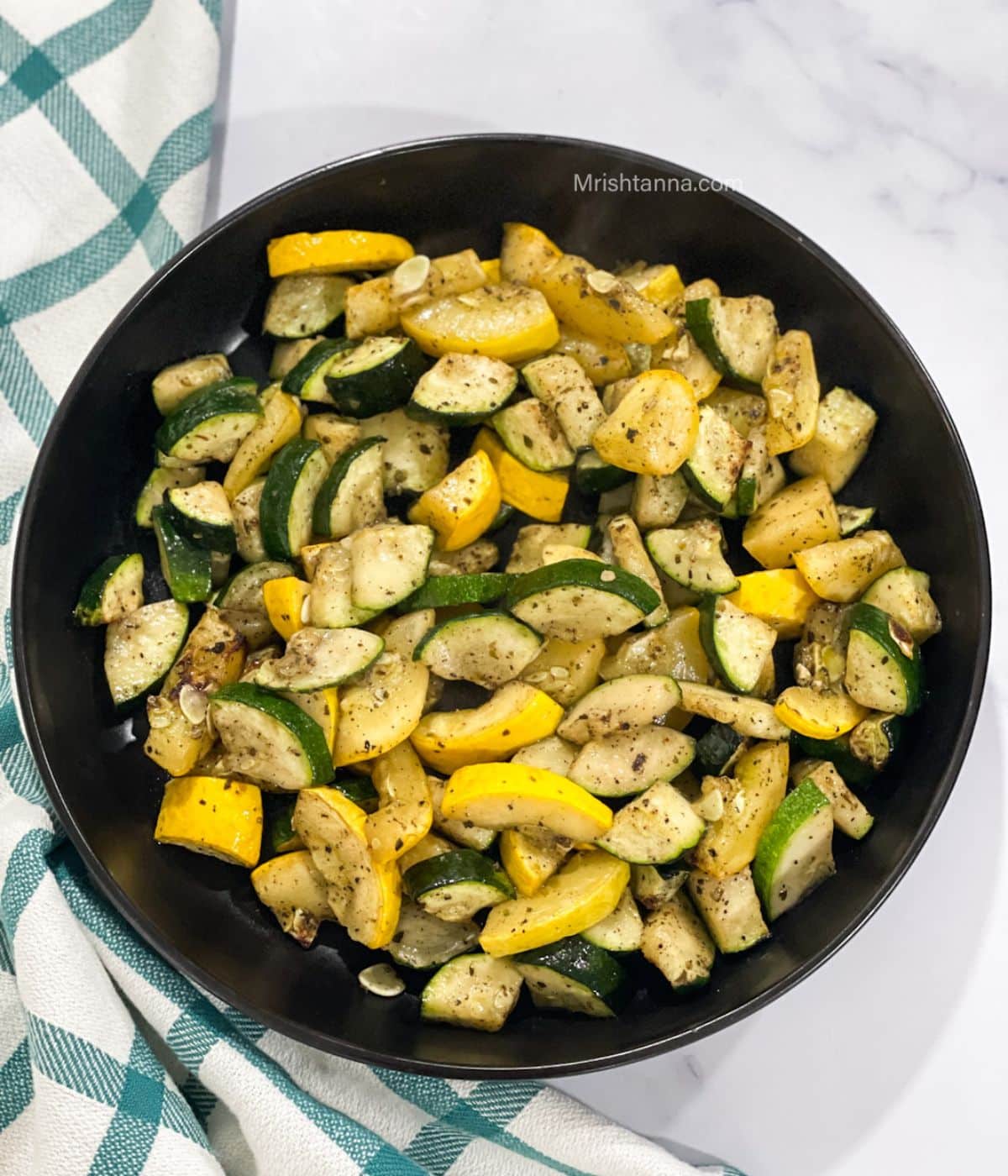 A plate of air fried zucchini and squash is on the table.