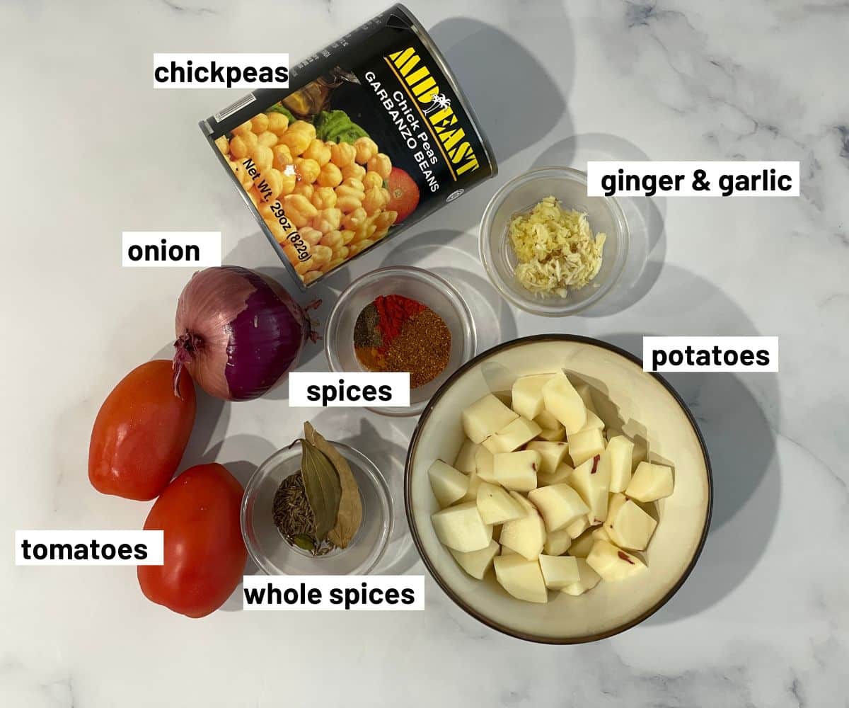 Ingredients to make aloo chana masala is on the table.