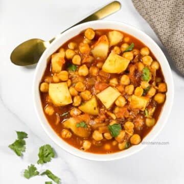 head shot of a bowl with potato chickpea curry.