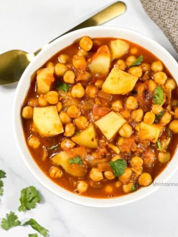 head shot of a bowl with potato chickpea curry.