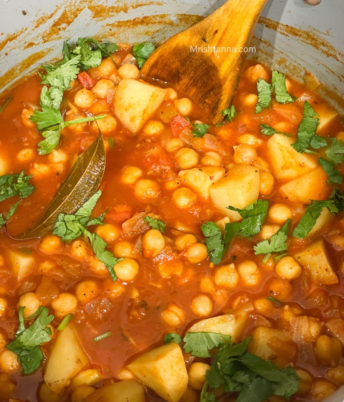 A pan is with potato chickpea curry.