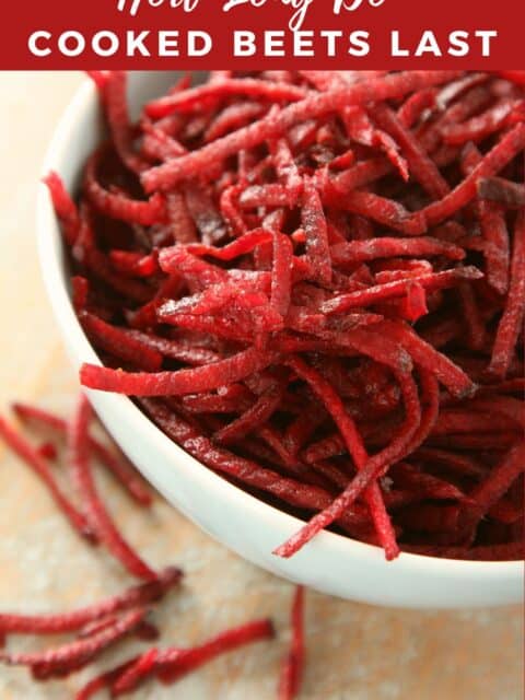 A bowl is with cooked grated beets.