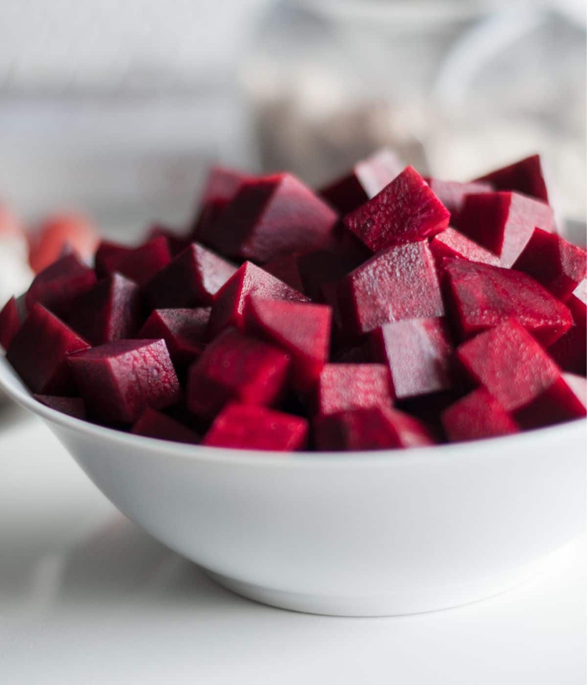 A bowl of cooked beets on the table.