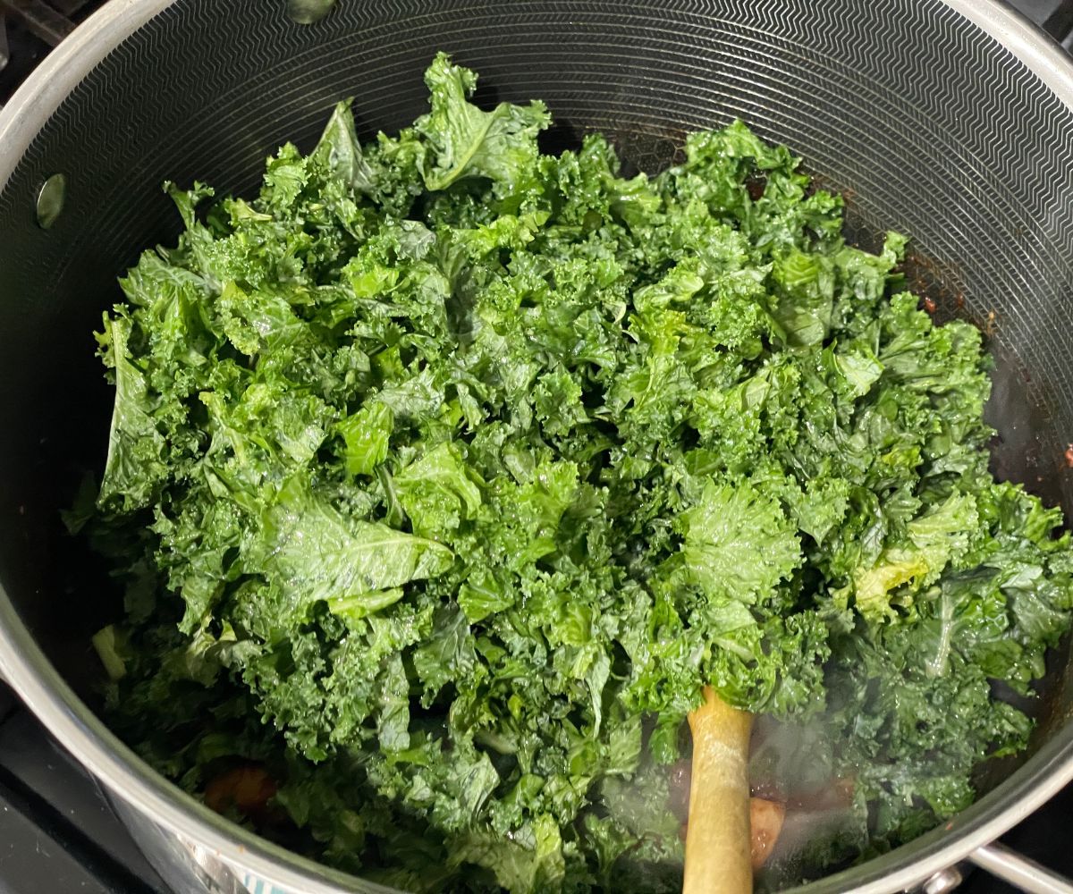 A pot is with kale and veggies.