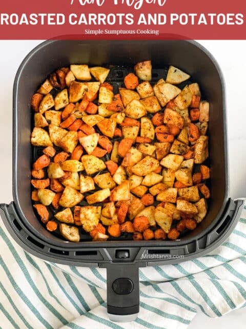 Roasted carrots and potatoes are inside the air fryer basket.