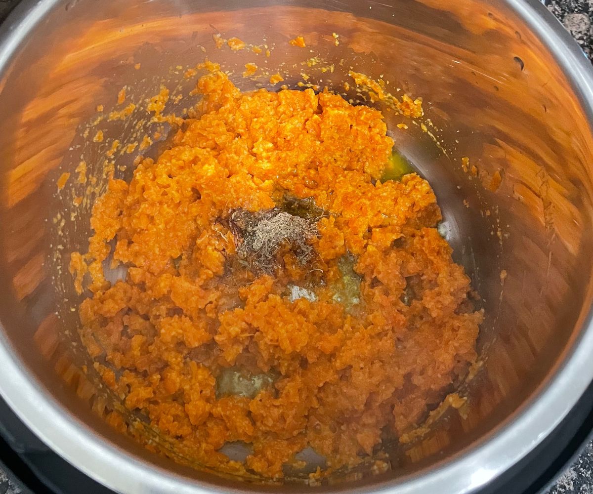 A pot is with vegan carrot halwa on cooking mode.